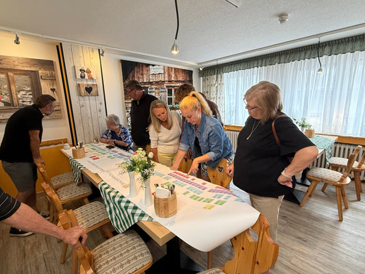 Cousins gather around a family history chart